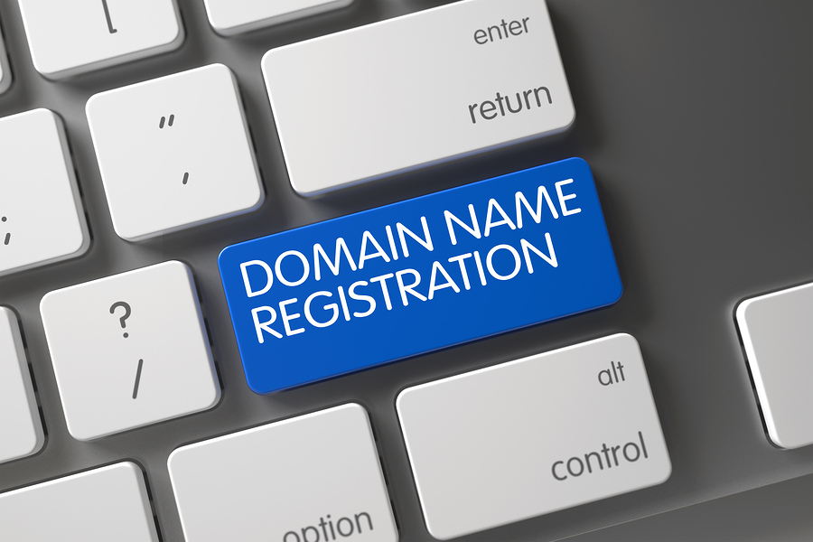Domain Name Registration Concept Laptop Keyboard with Domain Name Registration on Blue Enter Keypad Background, Selected Focus.