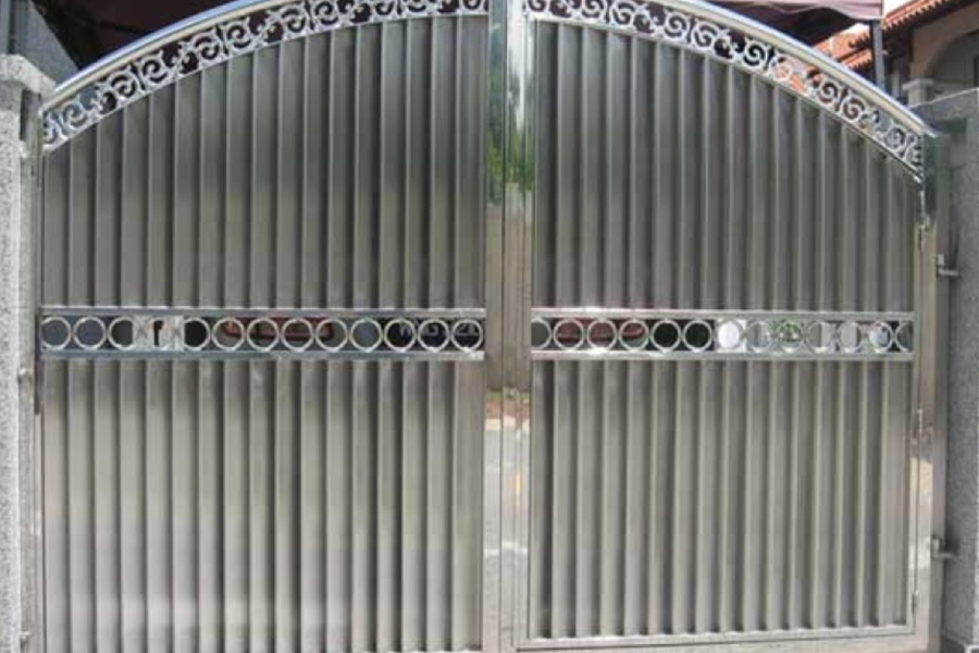 An elegant entrance features a shining steel gate.